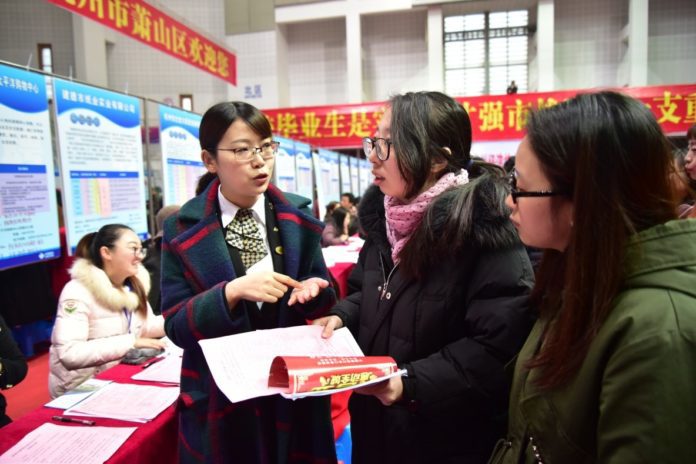University graduates University graduates look for jobs at a job fair in east China’s Zhejiang province, March 2. An increasing number of graduates now choose to work in China’s second- and third-tier cities, which roll out preferential policies to attract them to contribute to the cities’ development. (Photo from People’s Daily Online)
