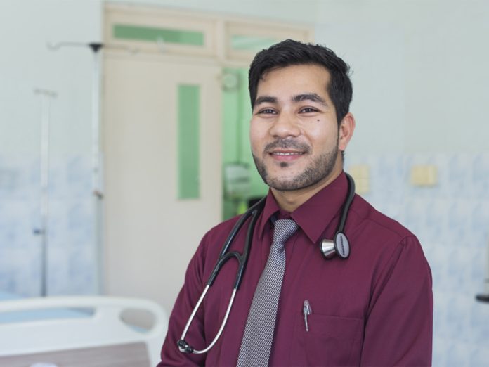 A Nepali migrant worker practicing medicine in the Maldives. Photo: Natalie Oren/IOM