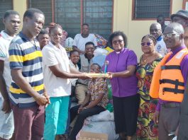 Synod Moderator Meridian Presbytery E P Church Ghana Rev Dr Vivian Balasu Addo Left Presenting The Items To The Nadmo Co Ordinator In Charge Of The St Kizito Camp Ms Gloria Dornutsor